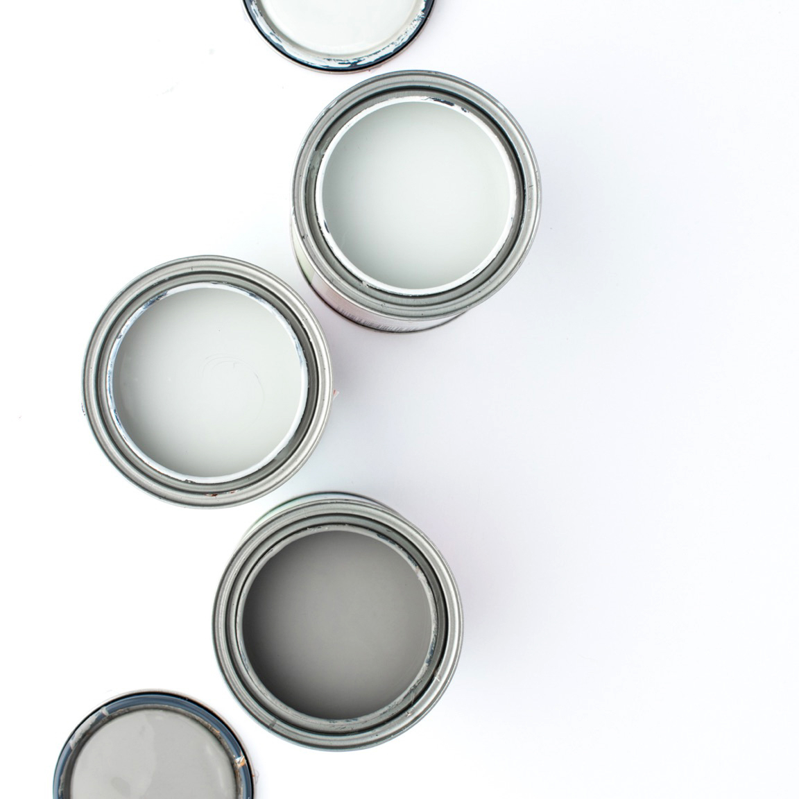 image of open paint cans with three shades of grey paint